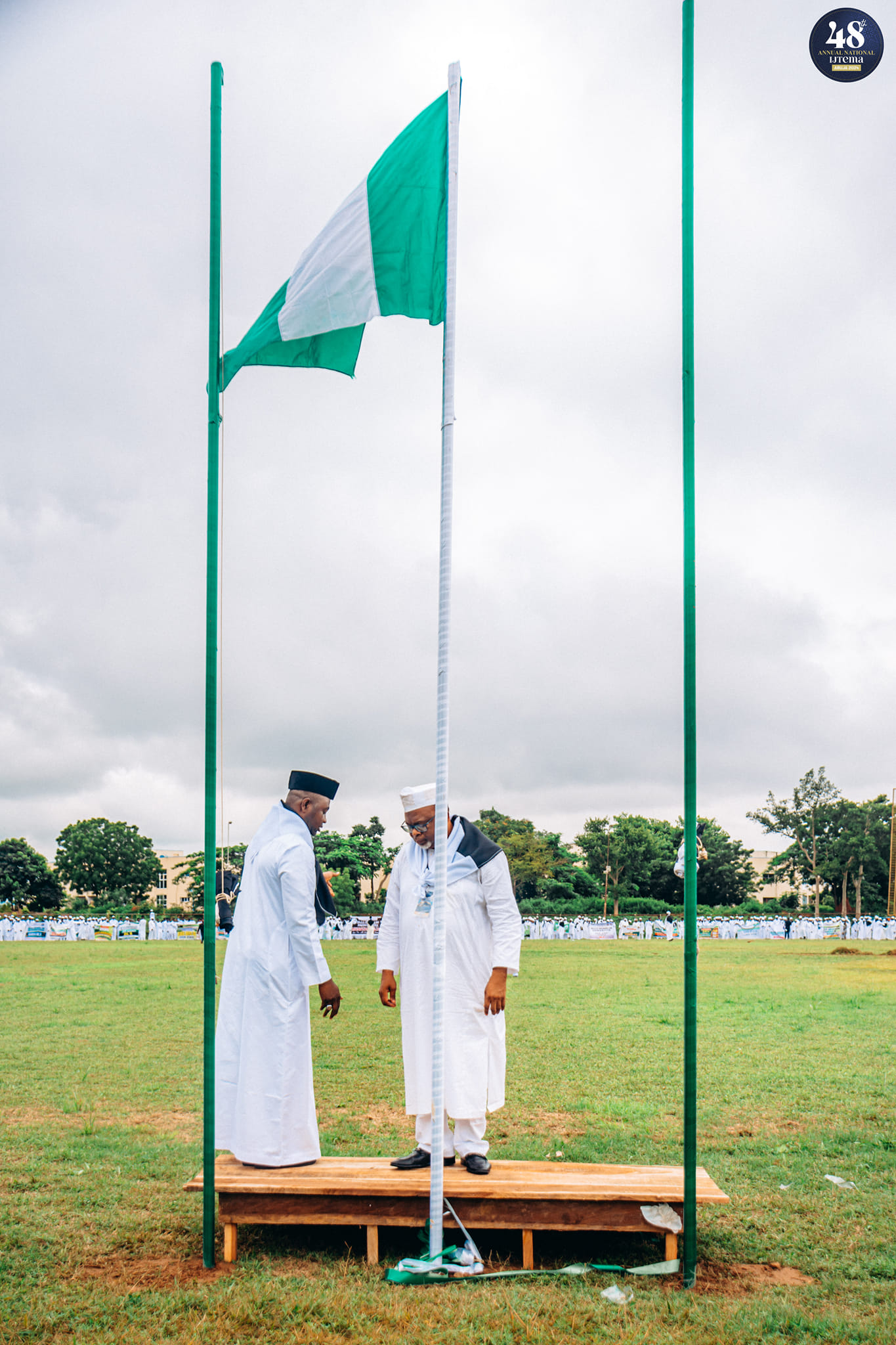 Ansār Delegates Raise Flags in Unity, Promoting Peace and Harmony